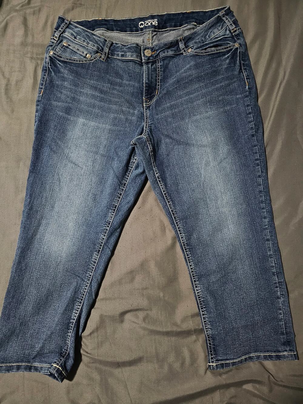 Dark wash denim jeans contrast stitching faded whiskering